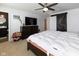 Bedroom featuring a ceiling fan, mounted television, and dark-stained sliding barn door at 7091 E Mardenis S Dr, Camby, IN 46113