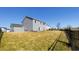 Spacious backyard featuring a manicured lawn, privacy fence, and a glimpse of a playset in the distance at 7139 Prelude Rd, Brownsburg, IN 46112