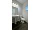 Simple half bathroom with pedestal sink and dark vinyl floor at 7139 Prelude Rd, Brownsburg, IN 46112