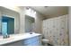 Bright bathroom featuring a double sink vanity, decorative mirror and stylish shower curtain at 7139 Prelude Rd, Brownsburg, IN 46112