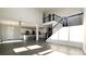 Open-concept living room with staircase, high ceilings, and wood floors at 7139 Prelude Rd, Brownsburg, IN 46112