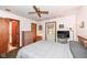Comfortable bedroom with a ceiling fan, tv, furnishings, and access to an ensuite bathroom at 7808 Crossgate Ln, Southport, IN 46227