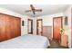 Cozy bedroom featuring neutral-toned walls, a ceiling fan, closet space, and an ensuite bathroom for added convenience at 7808 Crossgate Ln, Southport, IN 46227