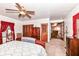 Well-lit bedroom with wooden furniture and a view to another living space at 7808 Crossgate Ln, Southport, IN 46227
