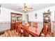 Traditional dining room featuring a ceiling fan and wood flooring at 7808 Crossgate Ln, Southport, IN 46227