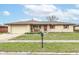 Charming ranch style home featuring a brick exterior, attached garage and well-manicured lawn at 7808 Crossgate Ln, Southport, IN 46227