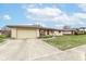 Ranch style home featuring a brick exterior, attached garage and concrete driveway at 7808 Crossgate Ln, Southport, IN 46227