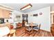 Eat-in kitchen featuring wooden cabinets, a breakfast table and wood flooring at 7808 Crossgate Ln, Southport, IN 46227