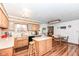Eat-in kitchen featuring wooden cabinets, a center island and wood flooring at 7808 Crossgate Ln, Southport, IN 46227
