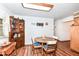 Eat-in kitchen featuring wooden cabinets, a breakfast table and wood flooring at 7808 Crossgate Ln, Southport, IN 46227