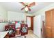 Well-lit laundry room equipped with modern red washer and dryer units and storage at 7808 Crossgate Ln, Southport, IN 46227