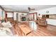 Inviting living room featuring a brick fireplace, wood floors, and comfortable seating at 7808 Crossgate Ln, Southport, IN 46227