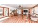 Open-concept living room featuring wood flooring, fireplace and entertainment center at 7808 Crossgate Ln, Southport, IN 46227