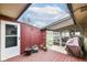 Outdoor patio featuring a wood deck, barbecue, covered walkway, and view to the front yard at 7808 Crossgate Ln, Southport, IN 46227