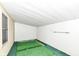 Enclosed sunroom with green carpet flooring, white wall paneling, large window view and ceiling paneling at 7808 Crossgate Ln, Southport, IN 46227