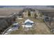 Detailed aerial view of a barn with paddocks, complemented by a house and surrounding fields at 7968 E 200 S, Whitestown, IN 46075