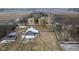 Close aerial shot showing a barn with multiple paddocks, a house, and agricultural land at 7968 E 200 S, Whitestown, IN 46075