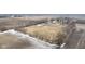 A beautiful aerial view of a home, barn, and fenced areas, set within an agricultural landscape at 7968 E 200 S, Whitestown, IN 46075
