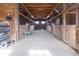 Interior of barn featuring stalls, lighting, and doors, creating a functional space at 7968 E 200 S, Whitestown, IN 46075