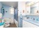 Charming blue bathroom with tiled walls and a traditional vanity at 7968 E 200 S, Whitestown, IN 46075