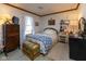 Comfortable bedroom featuring a cozy bed, wooden chest, and vintage dresser at 7968 E 200 S, Whitestown, IN 46075