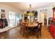 Inviting dining area with hardwood floors, pendant lighting, and access to an outdoor porch at 7968 E 200 S, Whitestown, IN 46075