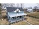 Eye-catching two-story house with a covered porch and a barn, situated in a rural area at 7968 E 200 S, Whitestown, IN 46075