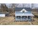 Charming two-story home with a welcoming covered porch and a detached garage; well-maintained exterior at 7968 E 200 S, Whitestown, IN 46075
