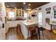 Spacious kitchen featuring a marble island, white cabinetry, and vintage decor at 7968 E 200 S, Whitestown, IN 46075