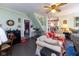 Cozy living room featuring classic decor, ceiling fan, and hardwood flooring at 7968 E 200 S, Whitestown, IN 46075