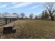 Expansive pasture with a wooden fence, leading to a barn and open sky at 7968 E 200 S, Whitestown, IN 46075