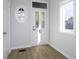 Bright entryway featuring a decorative glass door, oval window, and elegant trim work at 9652 Highgate N Cir, Indianapolis, IN 46250