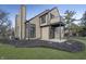Exterior of home with a small deck and neutral siding surrounded by landscaping at 9652 Highgate N Cir, Indianapolis, IN 46250