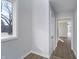 Hallway featuring wood floors, natural light from a large window, and leading to other living spaces at 9652 Highgate N Cir, Indianapolis, IN 46250