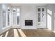 Bright living area featuring wood floors, a fireplace, and natural light from the windows at 9652 Highgate N Cir, Indianapolis, IN 46250