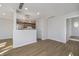 Open-concept living area with a fireplace, adjacent to a modern kitchen and stainless steel appliances at 9652 Highgate N Cir, Indianapolis, IN 46250