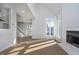 Bright living room with hardwood floors, fireplace, and large windows offering ample natural light at 9652 Highgate N Cir, Indianapolis, IN 46250