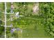 An aerial view shows the neighborhood with mature trees and sprawling lawns surrounding the homes at 9841 E Raymond St, Indianapolis, IN 46239