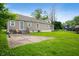 The backyard features a patio, lawn, and a charming single-story house with tan siding at 9841 E Raymond St, Indianapolis, IN 46239