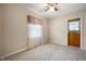 A comfortable carpeted bedroom featuring neutral walls, natural light and a ceiling fan at 9841 E Raymond St, Indianapolis, IN 46239