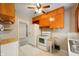 Functional kitchen with wooden cabinetry and white appliances, offering a practical cooking space at 9841 E Raymond St, Indianapolis, IN 46239