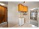 A cozy kitchen featuring light wood cabinets, tiled flooring, and view of an adjacent room at 9841 E Raymond St, Indianapolis, IN 46239