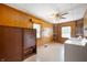Spacious laundry room with wood-paneled walls, tile flooring, and modern washer and dryer units at 9841 E Raymond St, Indianapolis, IN 46239