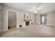 Cozy living room with carpet, neutral walls, vintage fireplace and a ceiling fan for comfortable living at 9841 E Raymond St, Indianapolis, IN 46239