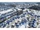 Sweeping aerial view of neighborhood showcasing orderly street design and snow-covered rooftops during winter at 10953 Mount Vernon N Trl, Indianapolis, IN 46229