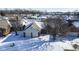 Aerial view of home showcasing snow covered yard, roof, driveway and neighborhood in the winter at 10953 Mount Vernon N Trl, Indianapolis, IN 46229
