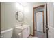 Well-lit bathroom featuring round mirror, vanity and tile flooring at 10953 Mount Vernon N Trl, Indianapolis, IN 46229