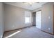 Carpeted bedroom featuring a window, a closet, and a ceiling fan at 10953 Mount Vernon N Trl, Indianapolis, IN 46229