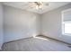 Bedroom featuring a ceiling fan, a window, and neutral carpet at 10953 Mount Vernon N Trl, Indianapolis, IN 46229