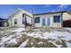 Back exterior featuring a porch swing, sliding glass doors and snow covered yard at 10953 Mount Vernon N Trl, Indianapolis, IN 46229